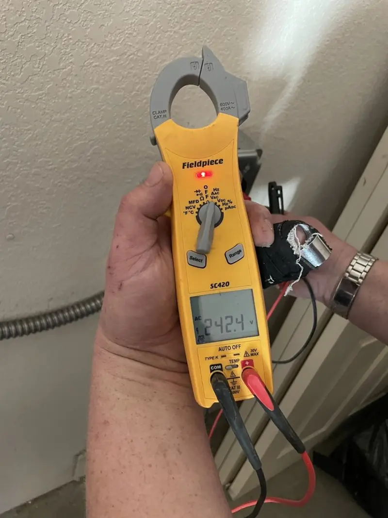 Voltage testing with clamp meter during Ceiling Fan Installation in Round Lake Beach